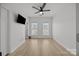 Bright bedroom with two windows, ceiling fan, hardwood floors, and modern decor at 11406 Potters Row, Cornelius, NC 28031