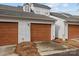 Attached garage and driveway, with mulched landscaping, and vinyl siding at 11406 Potters Row, Cornelius, NC 28031