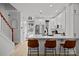 Bright kitchen featuring white cabinets, stainless appliances, and a large island at 11406 Potters Row, Cornelius, NC 28031