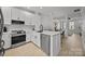 Well-lit kitchen boasts a large island with seating, stainless steel appliances, and open floor plan at 11406 Potters Row, Cornelius, NC 28031