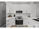 Modern kitchen with stainless steel oven, built-in microwave and white cabinets at 11406 Potters Row, Cornelius, NC 28031