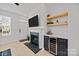 Cozy living room featuring a fireplace, beverage cooler and floating shelves at 11406 Potters Row, Cornelius, NC 28031