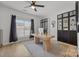 Bright home office with natural light, modern desk, and built-in shelving units at 11406 Potters Row, Cornelius, NC 28031