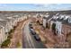 Scenic street view showcasing charming homes, flowering trees and ample parking at 11406 Potters Row, Cornelius, NC 28031