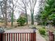 Backyard view of a home featuring a small patio and a wooded area at 1200 Berkshire Dr, Kannapolis, NC 28081