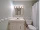 Bathroom features a vanity with a sink, mirror with lighting and a shower with a white curtain at 1200 Berkshire Dr, Kannapolis, NC 28081