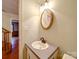 A half bath featuring a vanity with decorative mirror and classic fixtures at 1200 Berkshire Dr, Kannapolis, NC 28081