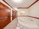 Bathroom featuring a jacuzzi tub with marble tiling and unique design elements at 1200 Berkshire Dr, Kannapolis, NC 28081