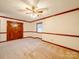 Spacious bedroom with neutral carpet, double doors and classic ceiling fan at 1200 Berkshire Dr, Kannapolis, NC 28081