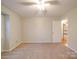 Bedroom with carpet, open doorway, light walls and a window at 1200 Berkshire Dr, Kannapolis, NC 28081