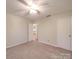 Bedroom with carpet, ceiling fan, and a white door to the hallway at 1200 Berkshire Dr, Kannapolis, NC 28081