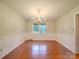 Traditional dining room with classic chandelier and wainscoting; bright natural light at 1200 Berkshire Dr, Kannapolis, NC 28081