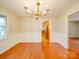 Dining room with traditional chandelier and wainscoting, open to kitchen at 1200 Berkshire Dr, Kannapolis, NC 28081
