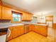 Spacious kitchen with wood cabinets and modern stainless steel appliances and fixtures at 1200 Berkshire Dr, Kannapolis, NC 28081