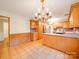 Eat-in kitchen featuring wood cabinetry, stainless appliances, and breakfast bar seating at 1200 Berkshire Dr, Kannapolis, NC 28081
