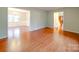 Spacious living room featuring hardwood floors, offering an open layout to the dining and entry area at 1200 Berkshire Dr, Kannapolis, NC 28081