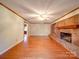 Open living room with hardwood floors, a brick fireplace, and neutral walls at 1200 Berkshire Dr, Kannapolis, NC 28081
