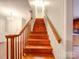 A home staircase with hardwood steps and stained wood banister at 1200 Berkshire Dr, Kannapolis, NC 28081