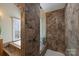 This tiled bathroom features a walk-in shower with glass enclosure at 12724 Cliffcreek Dr, Huntersville, NC 28078