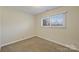 Neutral painted room with carpet and a big window at 12724 Cliffcreek Dr, Huntersville, NC 28078