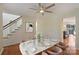 Dining room with marble table, ceiling fan, neutral decor, and adjacent staircase at 12724 Cliffcreek Dr, Huntersville, NC 28078