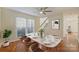 Bright dining room featuring modern decor, a stylish table, and a ceiling fan at 12724 Cliffcreek Dr, Huntersville, NC 28078