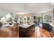 Open-concept kitchen featuring a center island, stainless steel appliances, and access to the backyard at 12724 Cliffcreek Dr, Huntersville, NC 28078