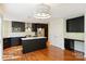 Modern kitchen with dark cabinets, stainless steel appliances, a center island, and hardwood floors at 12724 Cliffcreek Dr, Huntersville, NC 28078
