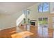 Bright and airy living room featuring a fireplace, vaulted ceiling, and hardwood floors at 12724 Cliffcreek Dr, Huntersville, NC 28078