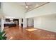 Open living room with high ceilings features hardwood floors, fan, and bright natural light at 12724 Cliffcreek Dr, Huntersville, NC 28078
