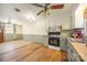 Well-equipped kitchen featuring white cabinets, stainless appliances, and durable wood flooring at 132 Stoneybrook Rd, Salisbury, NC 28147