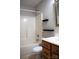 Bright bathroom featuring a tub-shower, stylish black shelving, and modern vanity with white countertop at 13840 Hastings Farm Rd, Huntersville, NC 28078