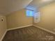 Carpeted bedroom with natural light from window, neutral tones, and a closet at 1637 Longfellow St, Charlotte, NC 28205