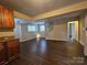 Open-concept living room with hardwood floors, neutral walls, and staircase at 1637 Longfellow St, Charlotte, NC 28205