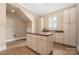 Laundry room with center island, ample storage, and natural lighting at 1718 Brawley School Rd, Mooresville, NC 28117