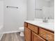Bright bathroom with wooden vanity, modern fixtures and hard flooring at 1765 Holliford Ct, Charlotte, NC 28215