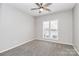 Bright bedroom with a ceiling fan, large window, and neutral decor at 1765 Holliford Ct, Charlotte, NC 28215