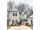 Charming townhouse featuring a covered entrance, well-kept landscaping, and classic architectural details at 1765 Holliford Ct, Charlotte, NC 28215