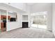 Bright open living room with a fireplace, access to a patio, and an open view to the kitchen at 1765 Holliford Ct, Charlotte, NC 28215