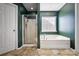 A bathtub and walk-in shower is featured in this beautifully designed bathroom at 184 Settlers Grove Ln # L7, Salisbury, NC 28146