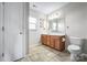 Bathroom features a wood vanity with generous countertop space and a tile floor at 184 Settlers Grove Ln # L7, Salisbury, NC 28146