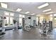 Well-equipped gym with fitness machines, weights, and large windows for natural light in the building at 1910 Colony Line Ct, Charlotte, NC 28210