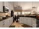 Bright kitchen with white cabinets, granite countertops, and a view into the breakfast area at 1910 Colony Line Ct, Charlotte, NC 28210