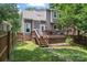 View of a home's back deck with wooden stairs and an enclosed yard, offering a private outdoor space at 1921 Kenilworth Ave, Charlotte, NC 28203