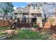 An inviting backyard features a wooden deck, a stone patio, and a well-maintained lawn at 1921 Kenilworth Ave, Charlotte, NC 28203