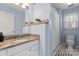 Clean bathroom with a granite countertop, a shower, and modern fixtures at 1921 Kenilworth Ave, Charlotte, NC 28203