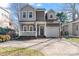Charming two-story home with a welcoming front porch and a well-maintained front yard at 1921 Kenilworth Ave, Charlotte, NC 28203
