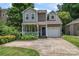 Charming two-story home with a covered porch, attached garage, and a well-manicured front yard at 1921 Kenilworth Ave, Charlotte, NC 28203