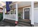 Inviting front porch with white railings, a hanging plant, and a decorative flag at 1921 Kenilworth Ave, Charlotte, NC 28203