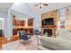Cozy living room with a stone fireplace, high ceilings, and an open kitchen layout at 1921 Kenilworth Ave, Charlotte, NC 28203